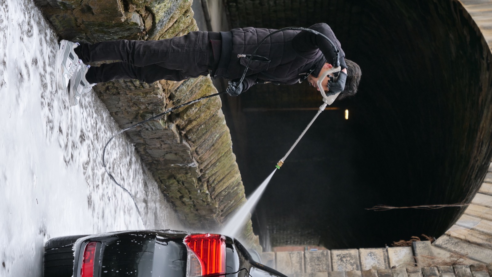 Student using a pressure washer for a safe pre-wash