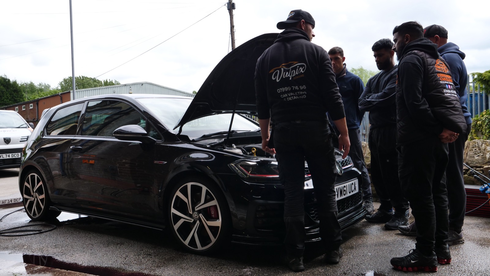 Students gathered around an engine bay